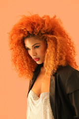 Fashionable young beautiful woman with afro hairstyle posing indoor. Vertical.