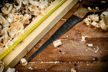 Hand saw with wooden shavings. 