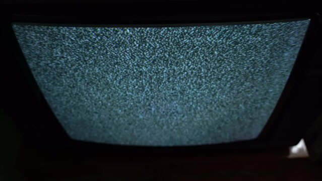 White noise on the TV screen in the dark top view