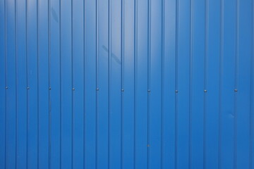 Dusty surface of electric blue wall with plastic siding