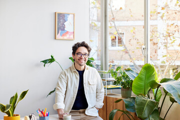 Smiling man sitting at home office table