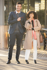 Fototapeta premium City portrait, confidence or happy business people, real estate agent or property investment team with pride in job career. Corporate partnership, black woman and man standing in San Francisco street