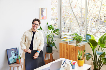 Confident entrepreneur smiling at workplace