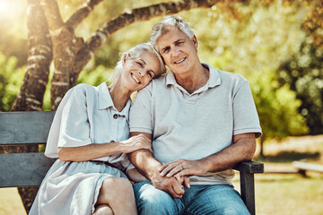 Love, retirement and portrait of couple on park bench with smile, relax and bonding time in nature...