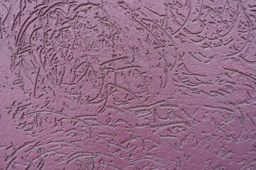 Macro of dusty purple wall with stucco worm finish
