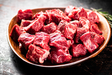 Chunks of fresh raw beef on a plate. 