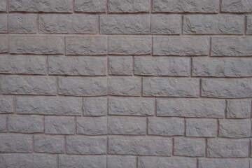 Pale grayish pink painted brick veneer wall texture