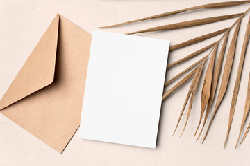 Wedding invitation or greeting card mockup with palm tree leaf and envelope