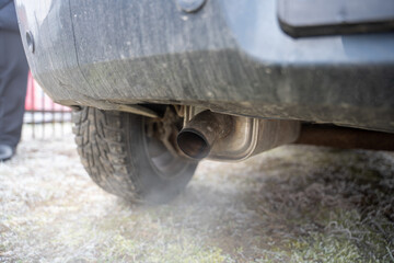 Close-up of white smoke emerging from exhaust pipe on gas powered automobile