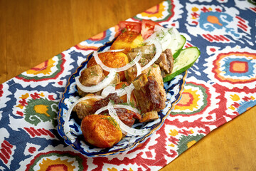 Shashlik or shish kebab from different types of meat served on a plate. Traditional grilled meat for Eastern cultures. Barbecue