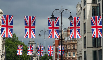 Fototapeta na wymiar Union Jack flags hanging over the Strand in central London, UK. 
