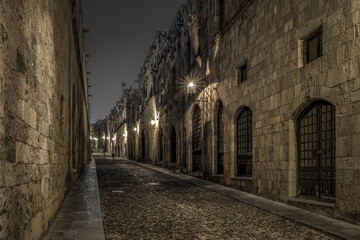 Fototapeta na wymiar Medieval Street of the Knights called Ippoton with cobblestone road in Old town of Rhodes city in Rhodes island, Greece