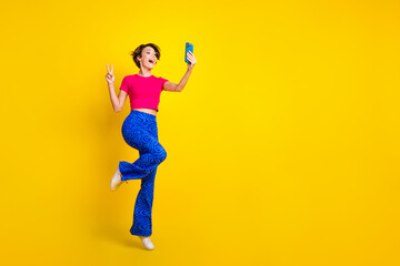 Fototapeta na wymiar Full length photo of attractive pretty lady blogger recording video make content v-sign empty space isolated on yellow color background