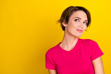 Fototapeta premium Photo of dreamy sweet lady wear pink t-shirt looking empty space isolated yellow color background