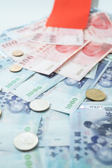 New Taiwan Dollar bill on white background. Red envelope packet chinese new year, hongbao on white background.