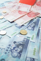 New Taiwan Dollar bill on white background. Red envelope packet chinese new year, hongbao on white background.