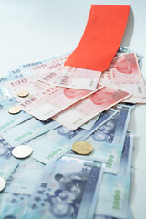 New Taiwan Dollar bill on white background. Red envelope packet chinese new year, hongbao on white background.
