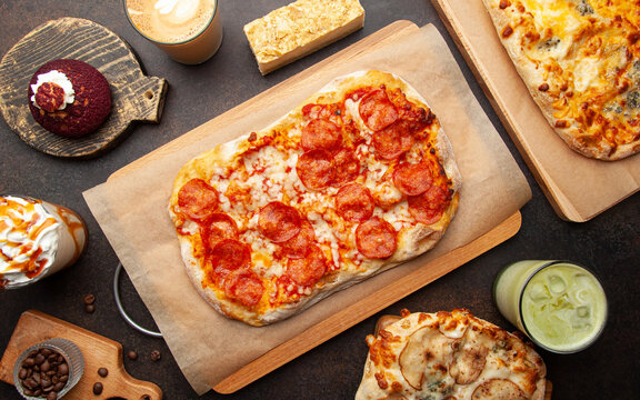 Many dishes. View from the top of the pizzas. Food assortment