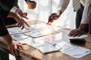 Close up of Diverse colleagues gather brainstorm discuss financial statistics at office meeting. finance, teamwork concept