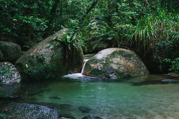 Boulders, waterfall and the lush rainforest in Mossman Gorge in far North Queensland.