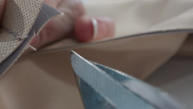 Scissors cut thread from fabric after sewing