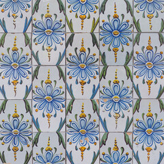 Fragment of building wall with colorful ceramic wall tiles, Azulejo close up. Abstract decorative background, textured ornate pattern for design or backdrop. Traditional ornate Portuguese architecture