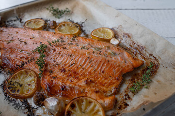 Oven roasted half salmon fillet with oilive oil, thyme, garlic and lemon