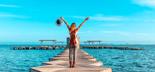 Happy woman standing on wooden pier above the sea ( santiago de la Ribera,  Man Menor, Province...