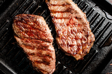 Aromatic grilled steak in a frying pan. 