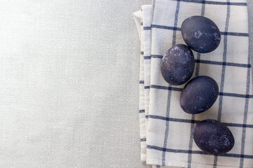 Blue easter eggs on a white checked towel. Painted eggs in hibiscus.