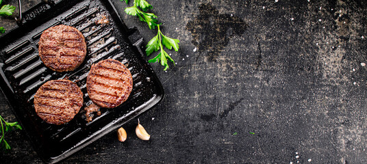 Grilled burger in a frying pan. 