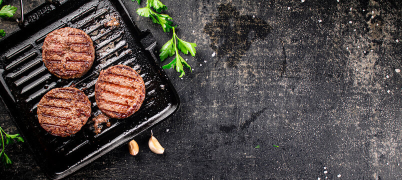 Grilled burger in a frying pan. 