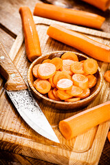 Sliced fresh carrots. On a wooden background.