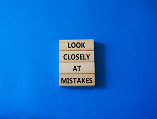Look closely at mistakes symbol. Wooden blocks with words Look closely at mistakes. Beautiful blue background. Business and Look closely at mistakes concept. Copy space.