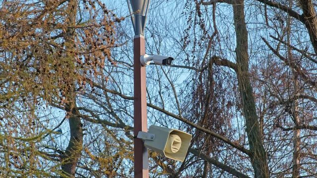 Outdoor PA System Speaker and Surveillance Camera Installed on Lamp Post by Public Playground