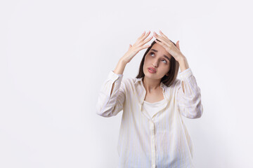 Portrait of a serious young woman showing stop gesture with her palm over white background