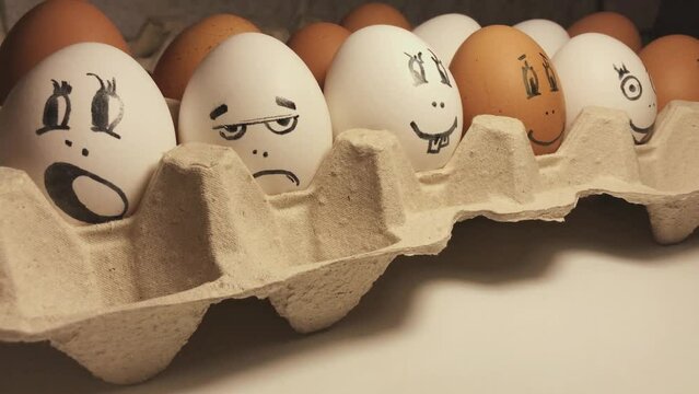 Eggs painted in cartoon faces with different grimaces. Funny and interesting cartoon faces. 