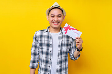 Smiling handsome Asian ethnicity young man 20s wearing casual clothes hat holding gift certificate...