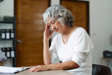 Fototapeta na wymiar Senior woman feeling blue worried about health problems