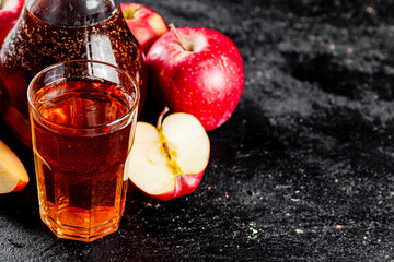 Juice from ripe apples in a jug and a glass on the table. 