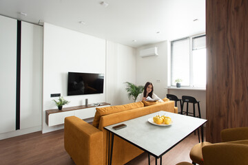 beautiful woman reading a magazine in the kitchen. apartment after renovation