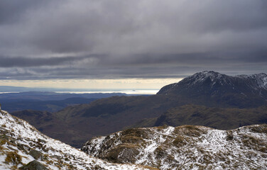 The dark mountains summit of Wetherlan under a layer of cloud from Langdale Pikes in the Cumbrian Lake District Mountains, England UK.