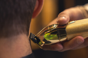 Barber trimming shaving cleints neck with electric razor