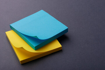 Yellow and blue office stickers for notes n a gray table. The concept of planning and time management. Copyspase.