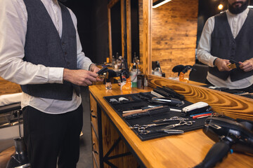 Fototapeta na wymiar Barber with hairdressing tools an the barbershop