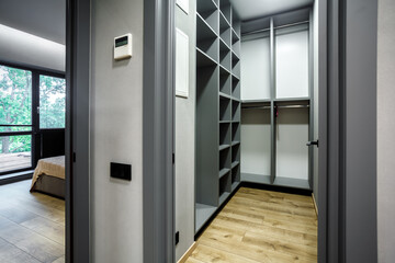 Modern gray scandinavian loft wood walk in closet with wardrobe