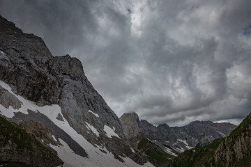 Mountain hiking Trail Road. Grey sky before thunderstorm. Between Italy and Austria: near Volaia Lake Raunchkofer Mountain (Lago di Volaia Monte Rauchkofel)