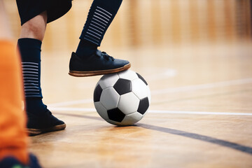 Football futsal player, ball, futsal floor. Indoor soccer sports hall. School boys on indoor...