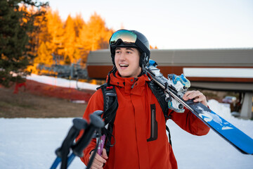 Boy walking with ski equipment