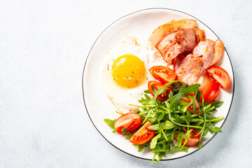 Healthy breakfast or lunch. Beacon, eggs and fresh salad.